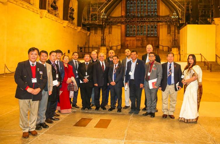 A group of people standing in front of a crowd posing for the camera

Description automatically generated